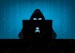 hacker-using-laptop-silhouette-with-skull-crossbones-logo-blue-binary-code-background_49941-125